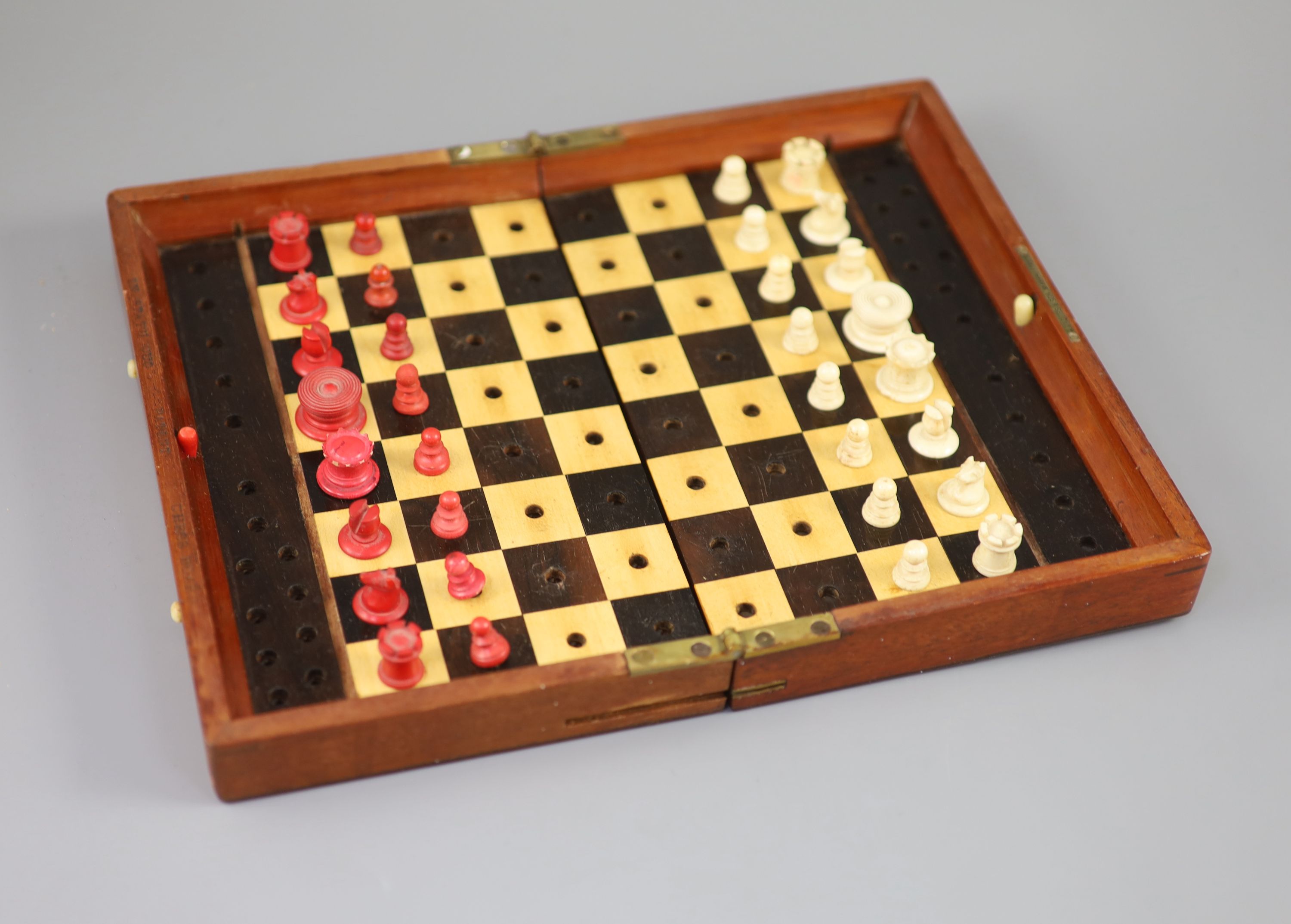 A Jaques & Son Ltd In Statu Quo bone travelling chess set, in mahogany case, c.1860, 9 x 5.5in.